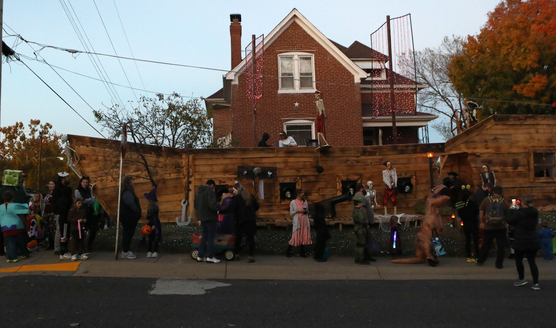 A line of trick-or-treaters forms
